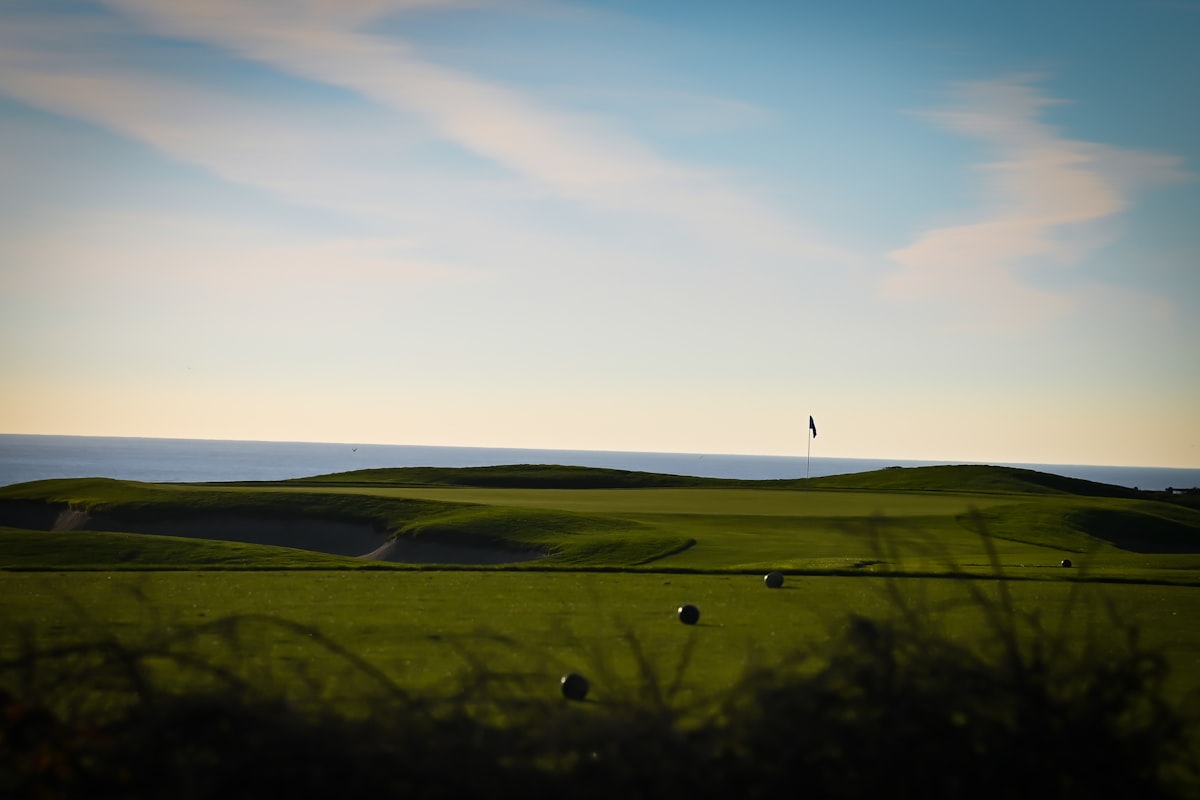 Placeholder image: an oceanside fairway and green at dusk with the sea on the horizon